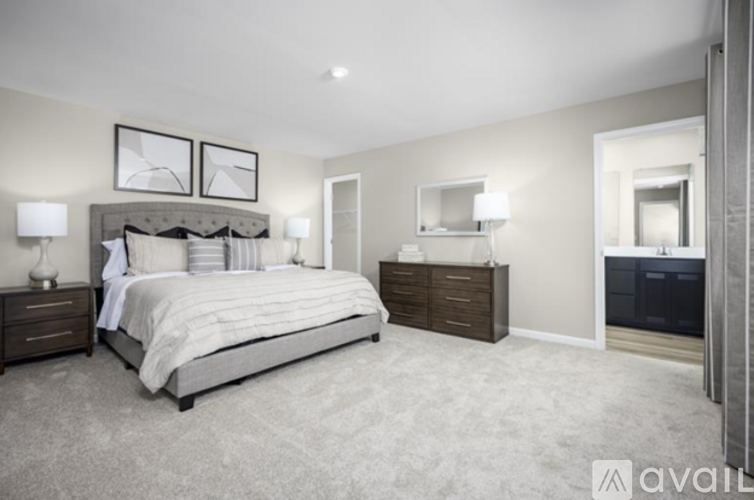 A bedroom with a large bed and a dresser.