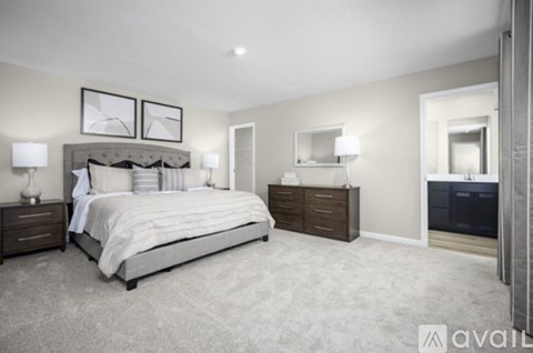 A bedroom with a large bed and a dresser.