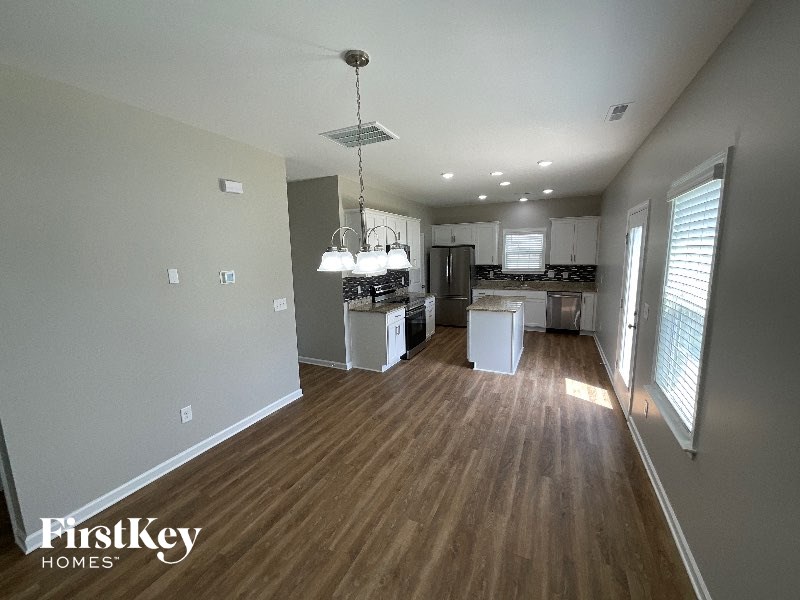 A kitchen with wooden floors and a FirstKey Homes logo.
