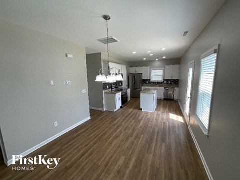 A kitchen with wooden floors and a FirstKey Homes logo.