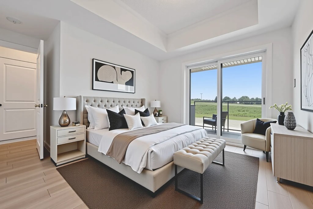 A bedroom with a large bed and a view of the outside.