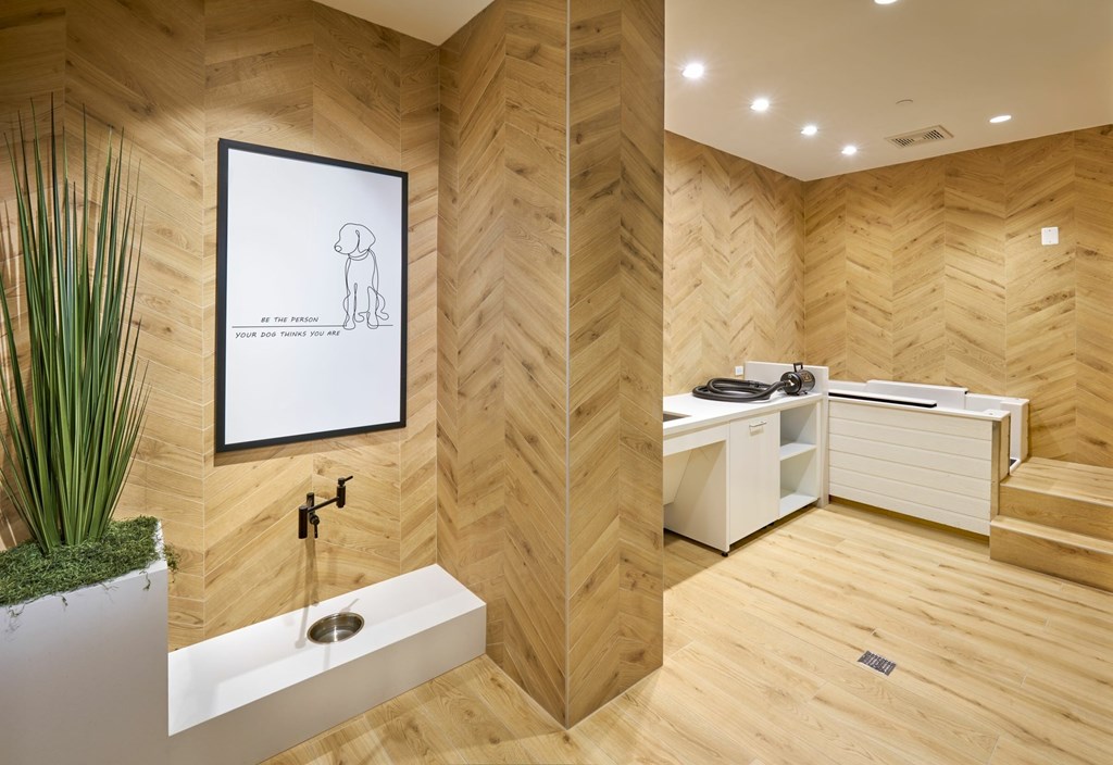 A bathroom with a wooden floor and a white sink.