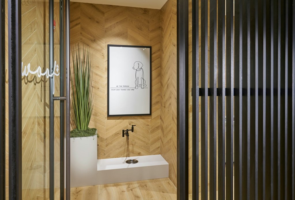 A bathroom with a wooden wall and a white sink.