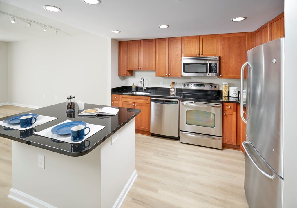 A kitchen with wooden cabinets and stainless steel appliances.