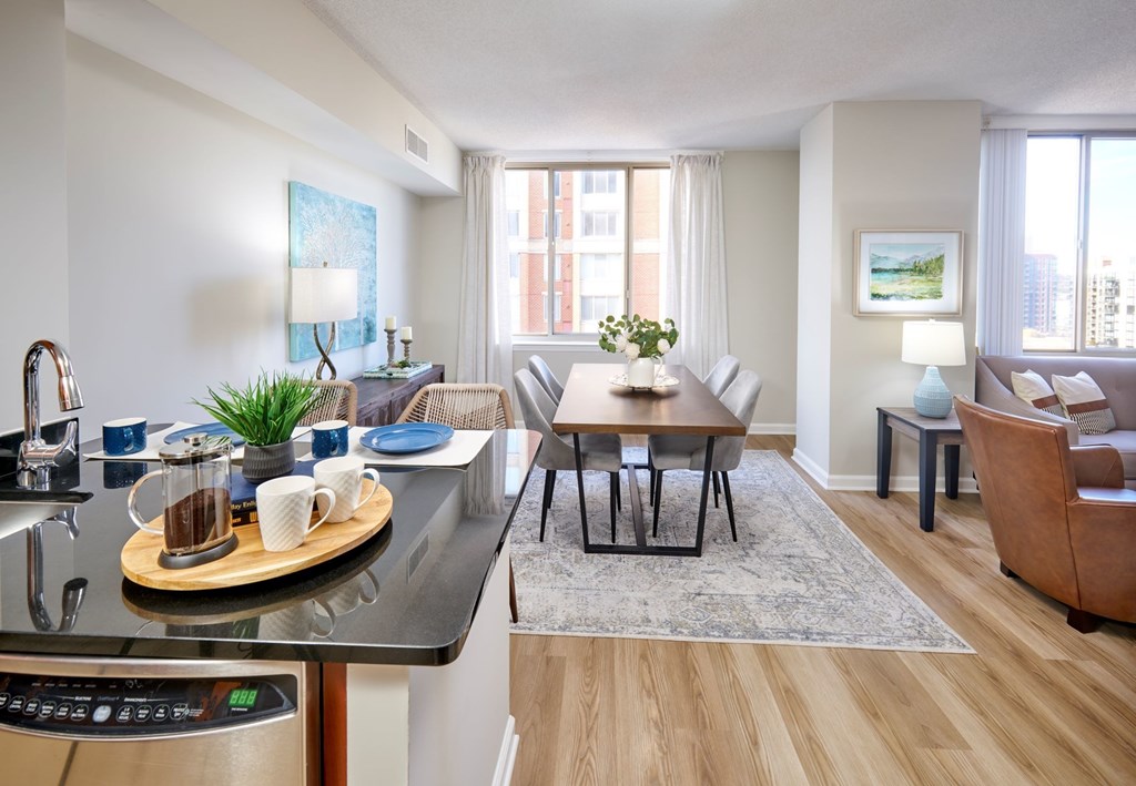 A modern kitchen with a breakfast bar and a dining area.