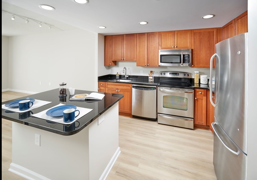 A kitchen with wooden cabinets and stainless steel appliances.