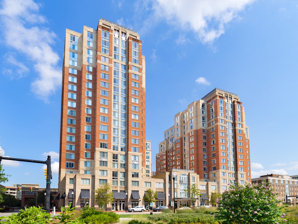 Two tall buildings with many windows are in the foreground.