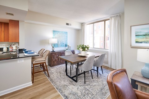 A dining room with a table and chairs.