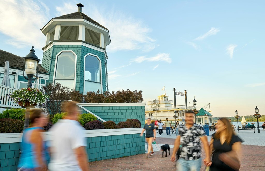 A group of people walking in front of a blue and white building.
