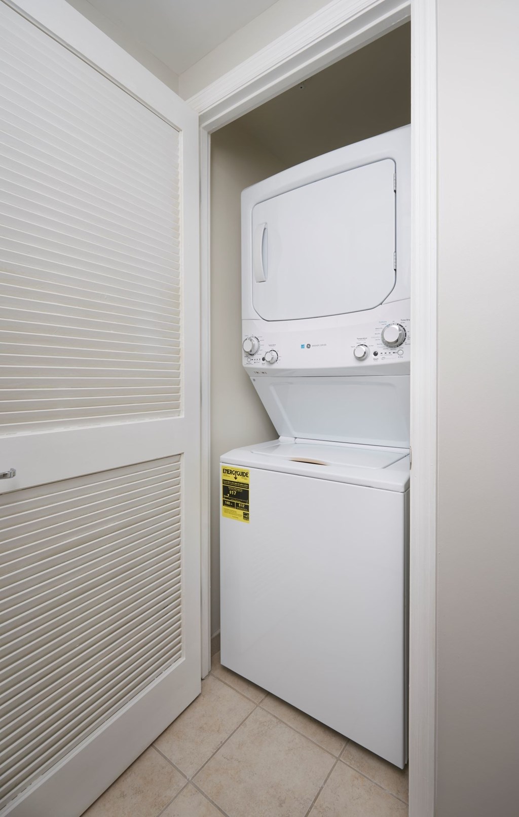 A white dryer is in a small room.