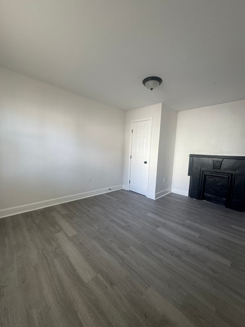A room with a fireplace and a door.