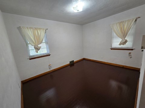 A room with brown walls and a brown floor.