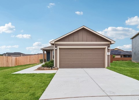 A house with a brown garage door and a driveway leading to it.