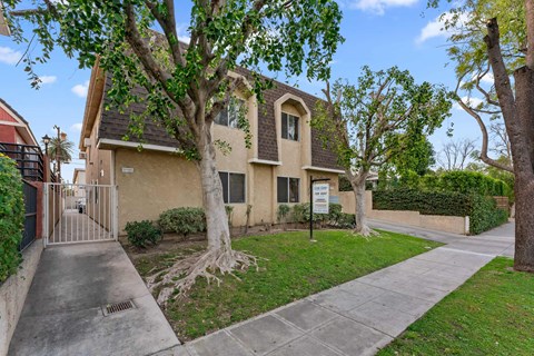 A house with a tree in front of it.