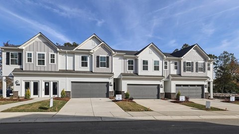 A row of houses with garages in front.