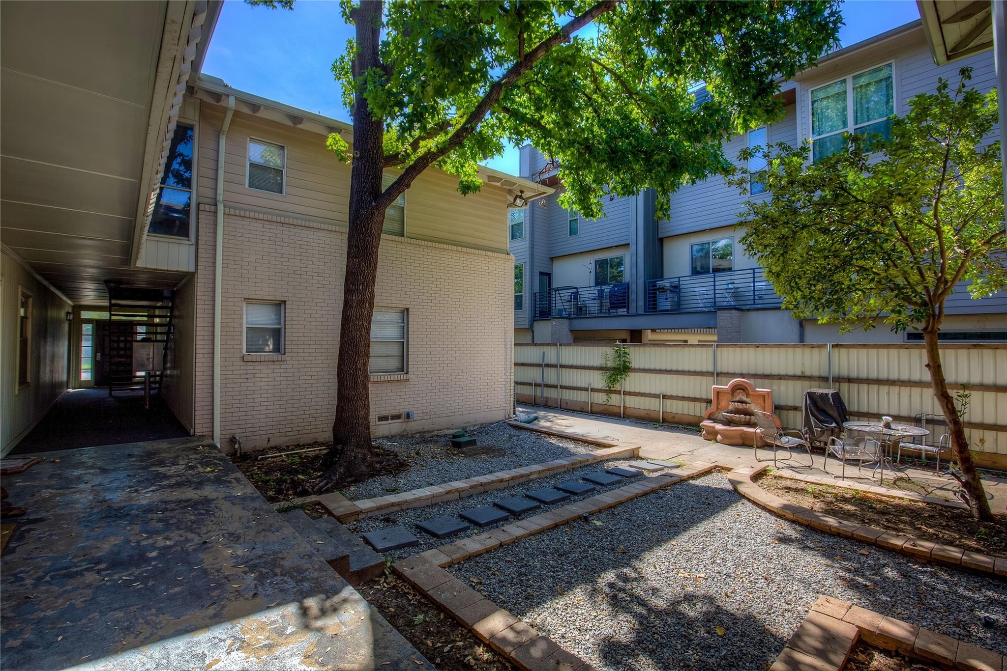 A tree in a courtyard of apartment buildings.