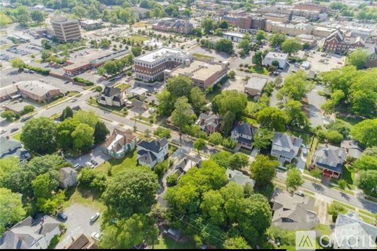 A bird's eye view of a residential area with houses and trees.