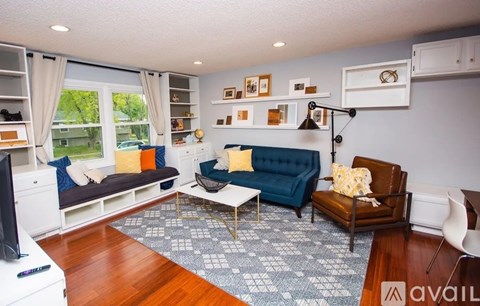 A living room with a blue couch and a television.