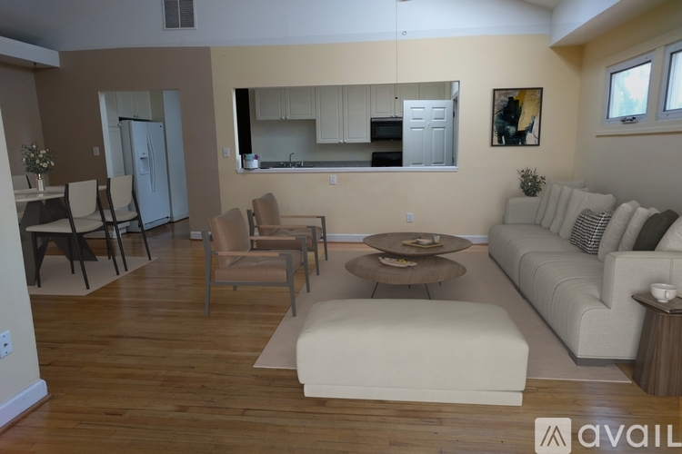 A living room with a couch, chairs, and a coffee table.
