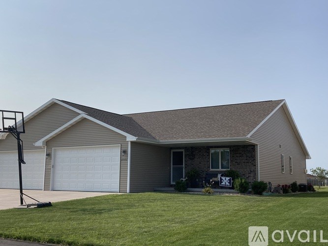 A house with a garage and a driveway in front.