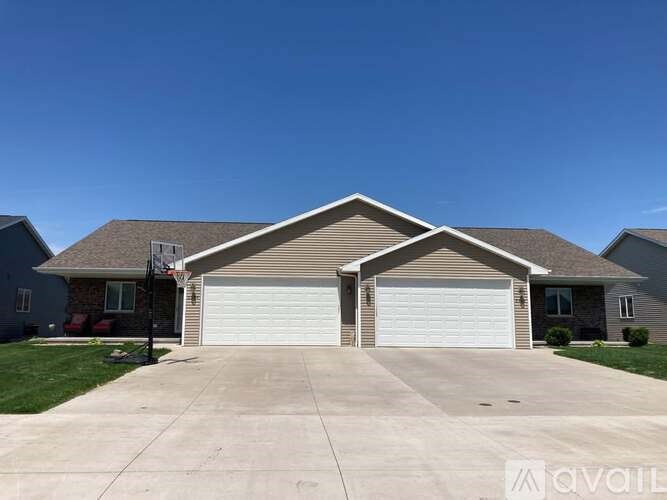 A house with a garage door in front.