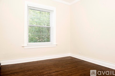 A room with a window covered in blinds.