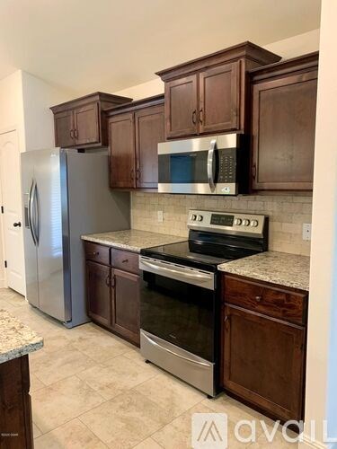 A kitchen with a stove top oven and microwave.