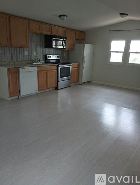 A kitchen with wooden cabinets and white appliances.