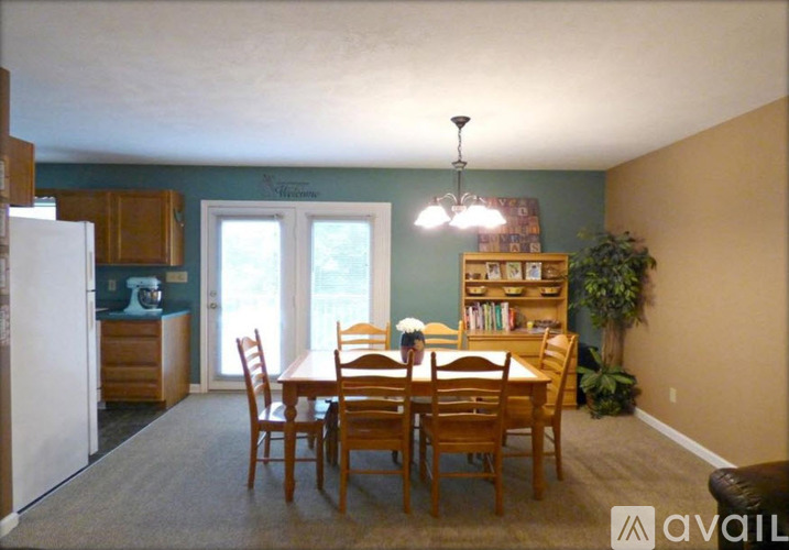 A dining room with a table and chairs.