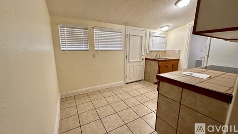 A kitchen area with a counter and cabinets.
