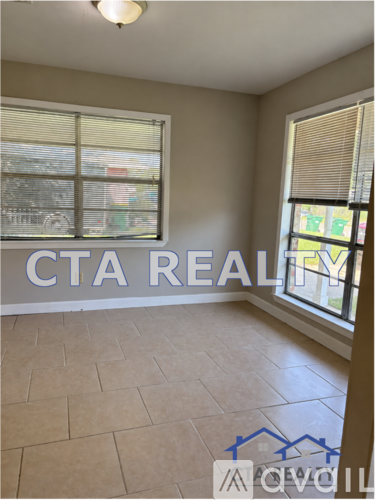 A room with a window and a tiled floor.