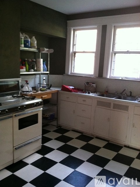 A kitchen with black and white checkered floor.