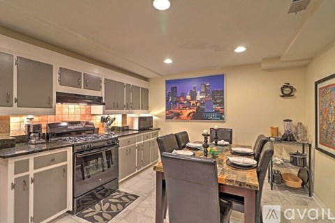 A kitchen with a dining table set for four.