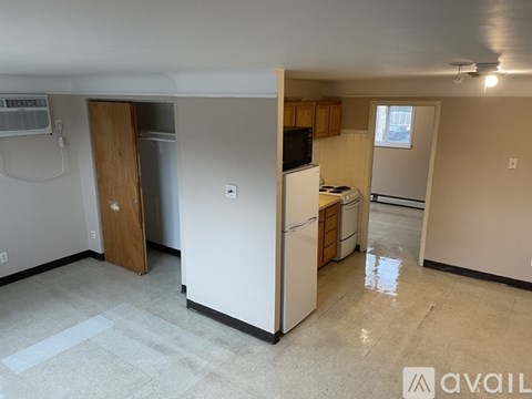 A kitchen area with a refrigerator, microwave, and oven.