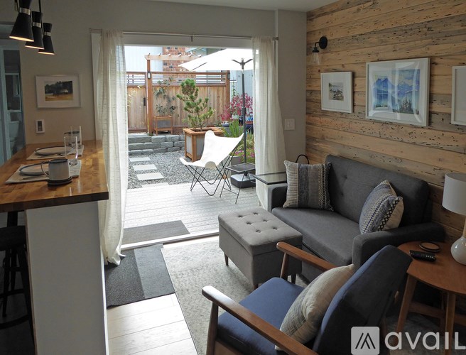 A living room with a grey couch and a wooden table.