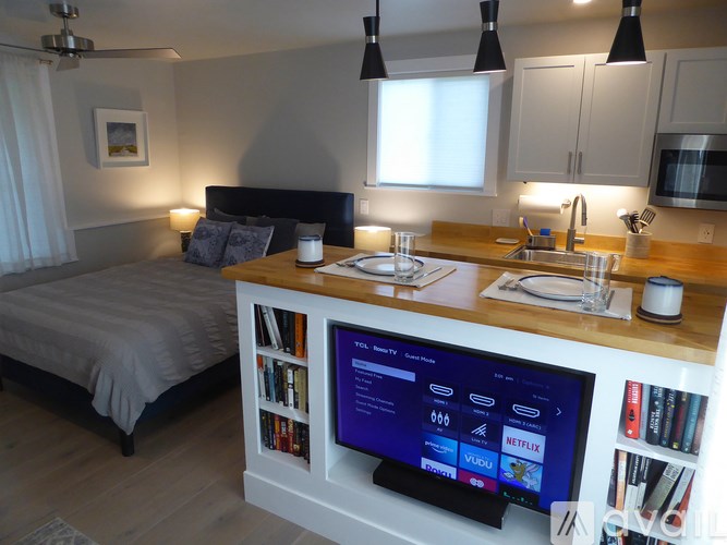 A modern bedroom with a built-in entertainment center.