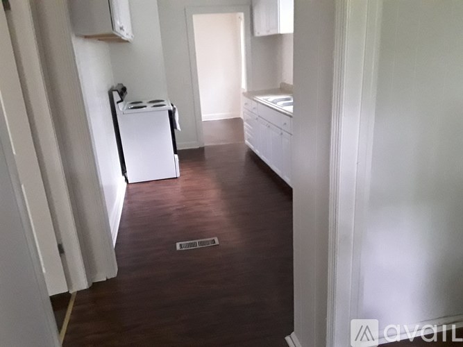 A kitchen with white cabinets and a white fridge.