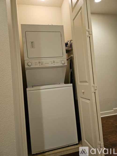A white dishwasher and oven are built into a wall.
