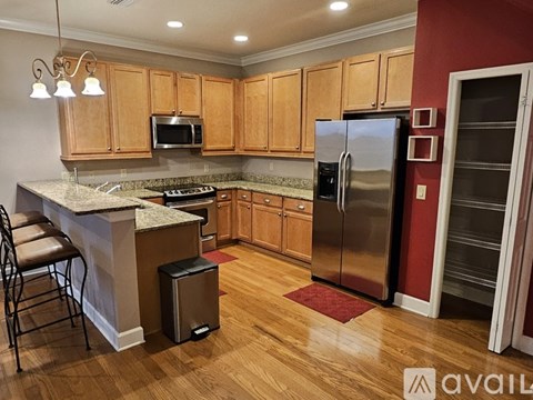 A kitchen with wooden cabinets and a granite countertop.