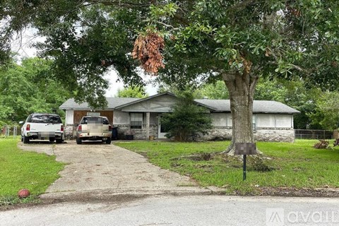 A house with a tree in front of it.