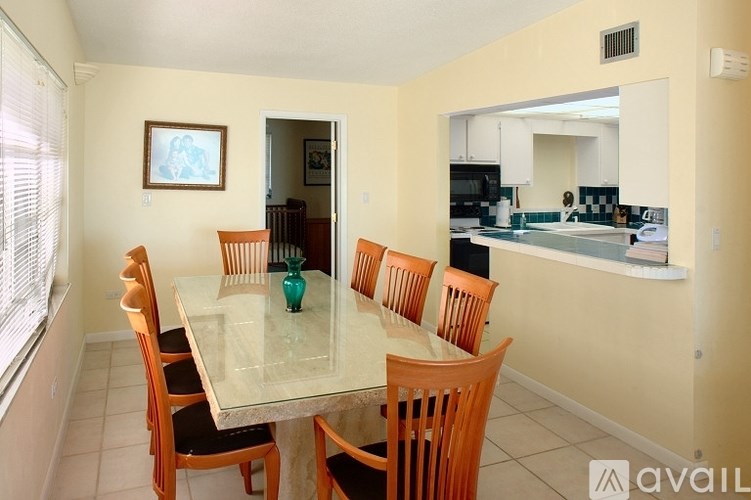 A dining room with a table and chairs is shown.