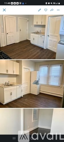 A kitchen with white cabinets and a window.