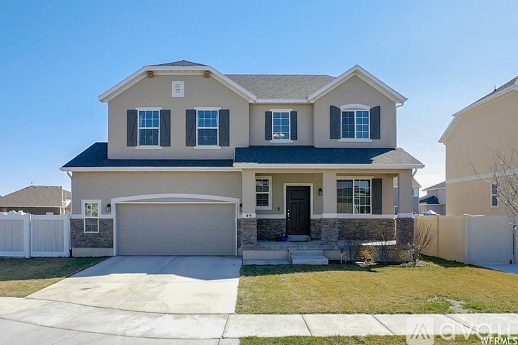 A two-story house with a garage and a driveway.