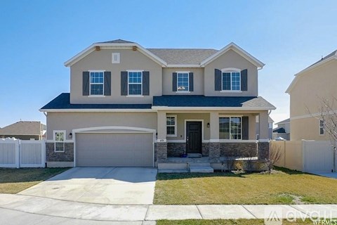 A two-story house with a garage and a driveway.