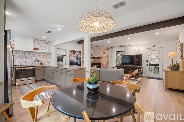 A modern dining room with a glass table and chairs.