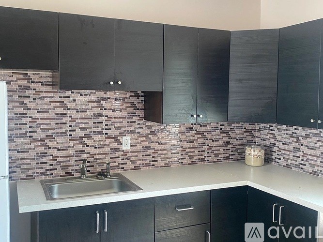 A kitchen with a sink and a counter.