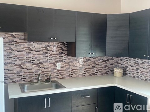 A kitchen with a sink and a counter.