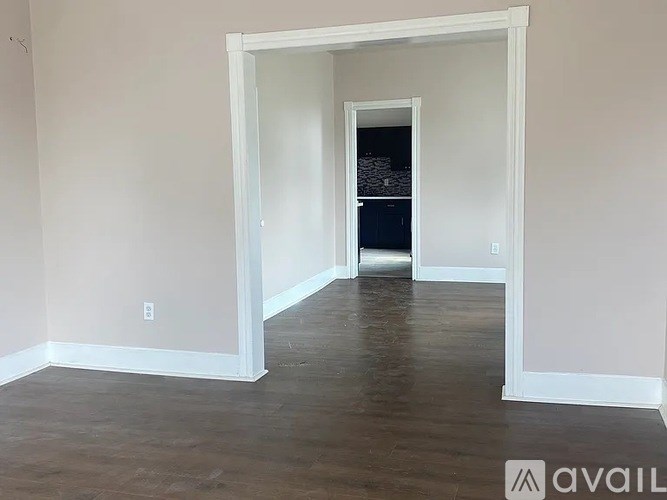 A room with a white doorway leading to another room.