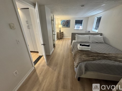 A bedroom with two beds and a painting on the wall.