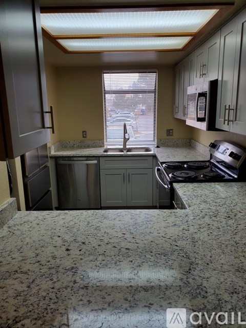 A kitchen with granite countertops and stainless steel appliances.